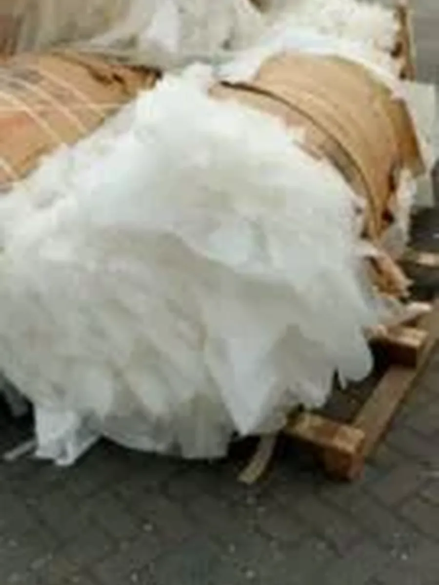 Outdoor bales of black rigid plastic scrap